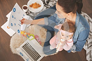 Top view photo of single mom working at home