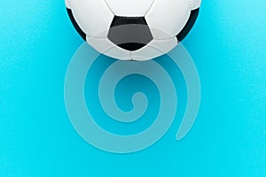 Top view photo of soccer ball over turquoise blue background with copy space