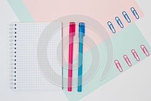 Top view photo of stationery on pink and blue background. Set of