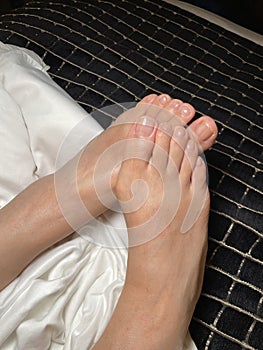 Top view  photo of woman feet and natural toes on bed