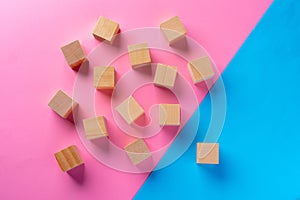 Top view photo of wooden blocks on pink and blue