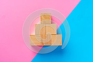 Top view photo of wooden blocks on pink and blue