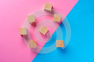 Top view photo of wooden blocks on pink and blue