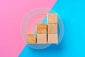 Top view photo of wooden blocks on pink and blue