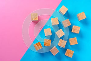 Top view photo of wooden blocks on pink and blue