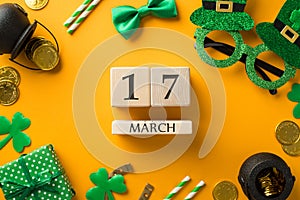 Top view photo of wooden cubes calendar 17 march st patricks day decor hat shaped party glasses straws green bow-tie giftbox