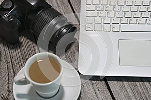 Top view photographer workspace desk ,with a camera , laptop and a coffee cup