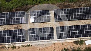 Top view on photovoltaic solar power panels. Drone aerial view of solar panels with water pumps, agricultural equipment for