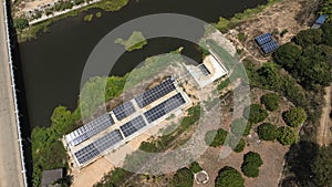 Top view on photovoltaic solar power panels. Drone aerial view of solar panels with water pumps, agricultural equipment for