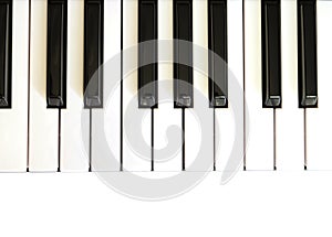 Top view of piano keyboard with white and black keys on white background