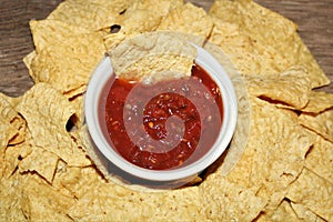 Picante Sauce in White Bowl Surrounded with Tortilla Chips photo