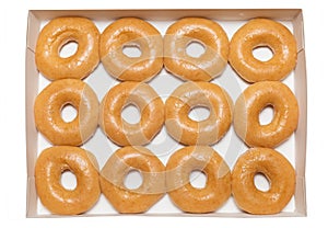 Top view picture of assorted glazed donuts in a box. Unhealthy food concept