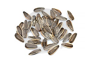 Top view of pile of black roasted organic sunflower seeds isolated on white background