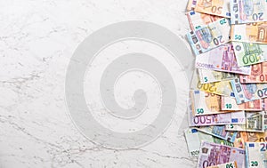 Top of view a pile euro banknotes on marble table