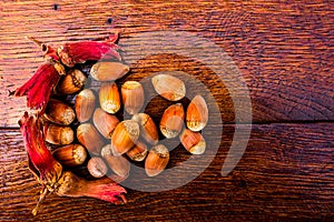 Top view of a pile of hazelnuts on a wooden surface