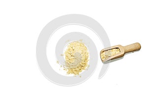 Top view of a pile of nutritional yeast flakes along with a wooden spoon. Vitamin b12 supplement used by vegetarians and vegans