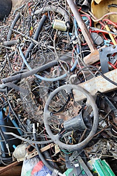 Top view of a pile of old wires, discarded car parts for reuse, recycling concept.