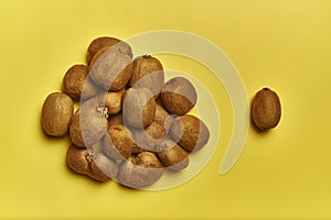 Top view of a pile of ripe kiwis isolated on a yellow background