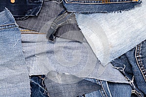 Top view of a pile of scraps of old blue jeans