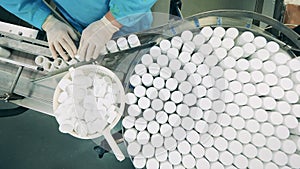 Top view of pill bottles getting sealed by a pharmacologist