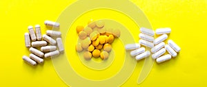 Top view pills of dietary supplements on yellow background. copy space. Concept of healthy life, vitamin. Banner