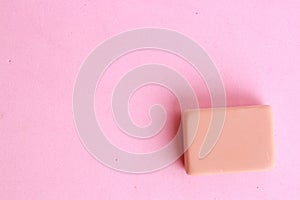 Top view of a pink eraser on a pink background