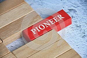 Top view of Pioneer text on red color wooden blocks. Founder concept. photo