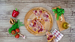 Top view of pizza cuts from wooden plate on the table. stop motion animation, 4K