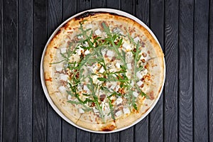 Top view of pizza with different kind of cheese with arugula