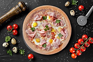 Top view of pizza with quail eggs and ham