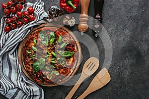 top view of pizza with wooden spatulas