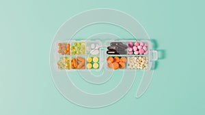 top view of plastic case with various sorted pills