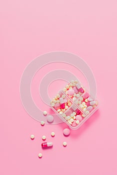 top view of plastic container with various pills