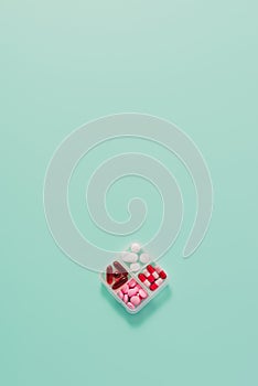 top view of plastic container with various sorted pills