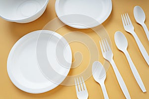 Top view - Plastick plate and spoon and fork. Disposable untensil