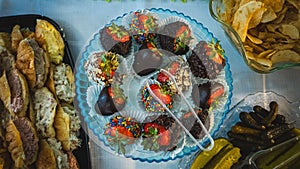 Top view of a plate of chocolate-covered strawberries for a banquet