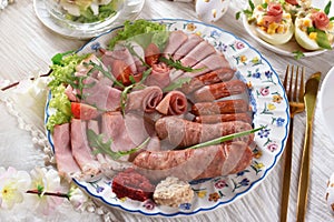 Top view of the plate with cold cuts and white sausage for trafitional Easter breakfast closeup