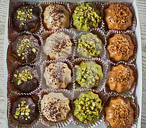 Top view of a plate of profiterole with different sort of flavored dressings