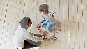 Top view of playful biracial mom and son playing