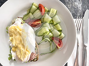 top view poached egg Benedict with salad for breakfast
