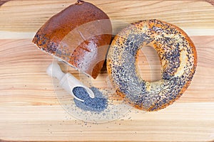 Top view of poppy seeds, bagel and poppy seed roll