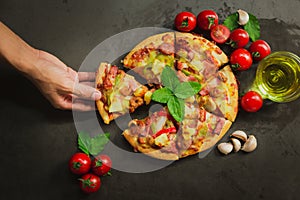 Top view of pork deluxe pizza,Tasty pork deluxe pizza on black background