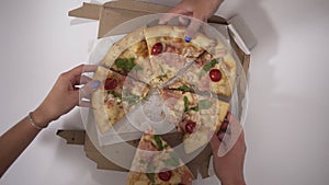 Top view portrait of people hands taking slices of pizza, group of friends sharing pizza together, colleagues ordered