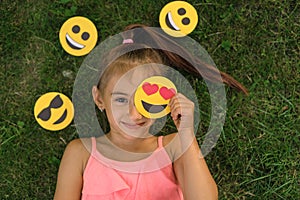 Top view Portrait of smiling girl covering one eye with emoticon with hearts