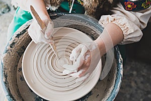 Top view of the potter`s hands and the process of his work
