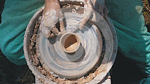 Top view on Potter`s Hands Work with Clay on a Potter`s Wheel