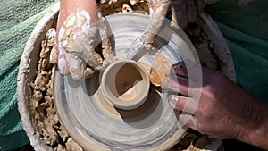 Top view on Potter`s Hands Work with Clay on a Potter`s Wheel. Slow motion