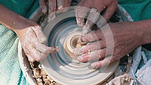 Top view on Potter`s Hands Work with Clay on a Potter`s Wheel. Slow motion