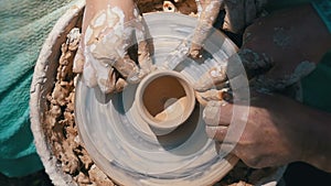 Top view on Potter`s Hands Work with Clay on a Potter`s Wheel. Slow motion