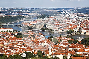 Top view of Prague, red roofs of the houses, the bridges over Vltava